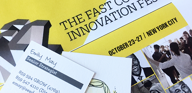 Emily May's business card on top of the Fast Company Innovation Festival brochure