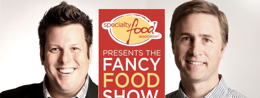 Photo of Jeff Johns and Sean Smyth in front of the Fancy Food Show logo