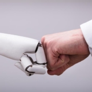 Robot hand fist bumping a human hand