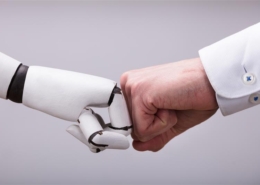 Robot hand fist bumping a human hand